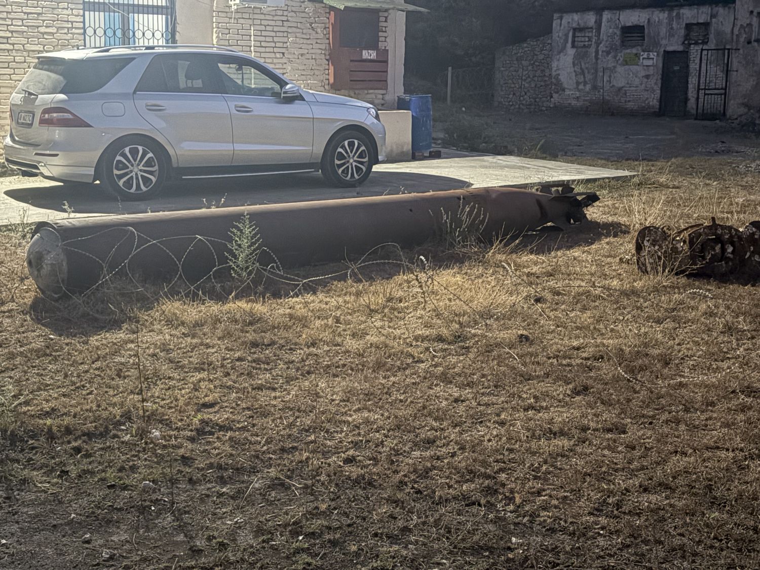 A torpedo, rusting in the grass.